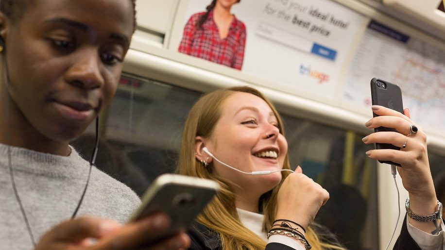 TfL Image Commuters using their phones in a tunnel on the jubilee line e1657273402722